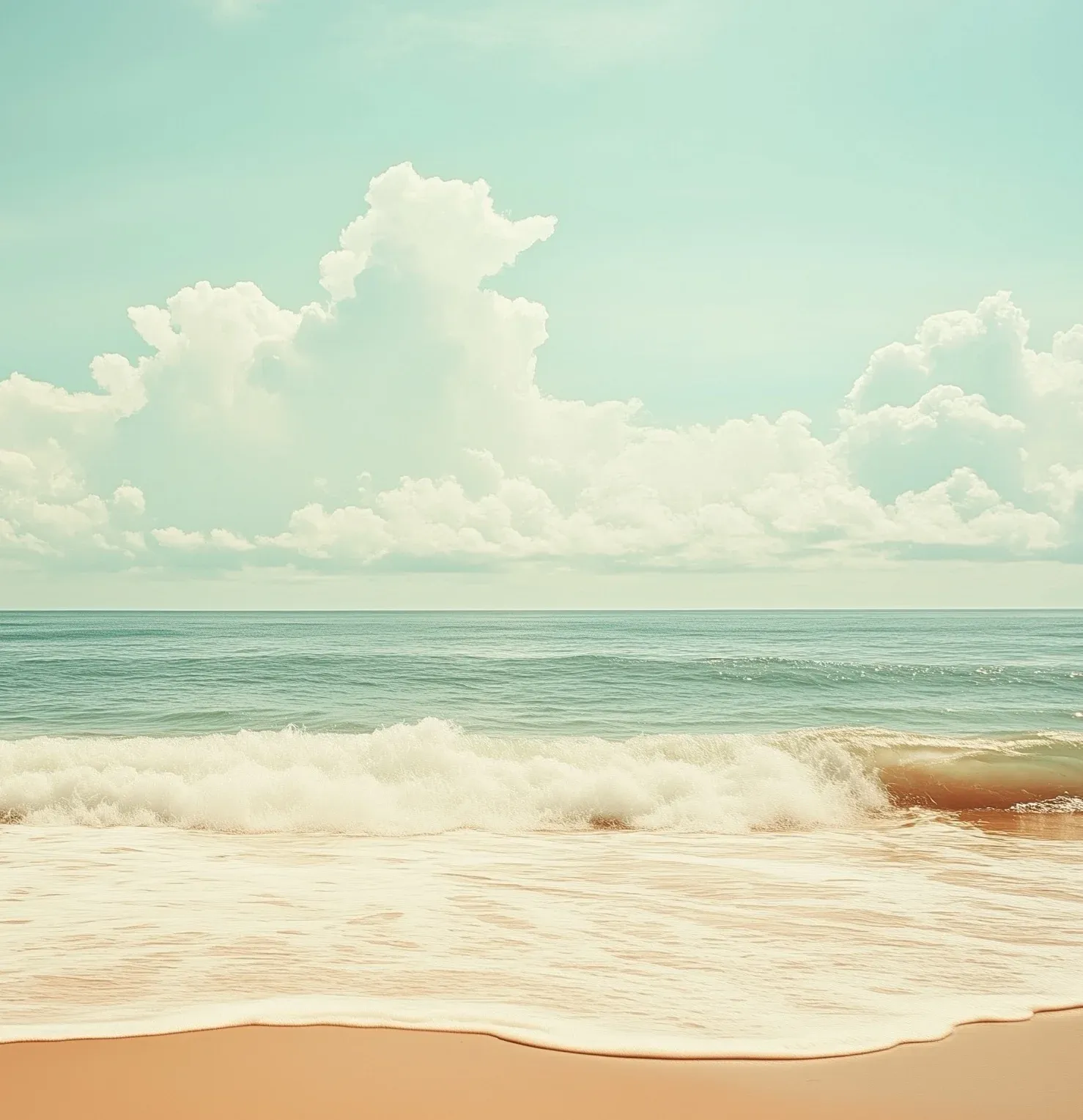 Ocean waves rolling onto a sandy beach